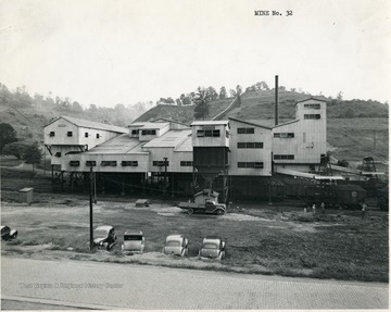 Preparation plant with cars parked outside.