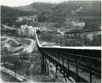 A coal preparation plant sits at the bottom of the hill.  Trains line up to the plant.