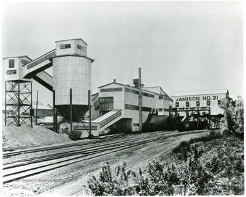 A processing plant with adjacent railroad tracks.