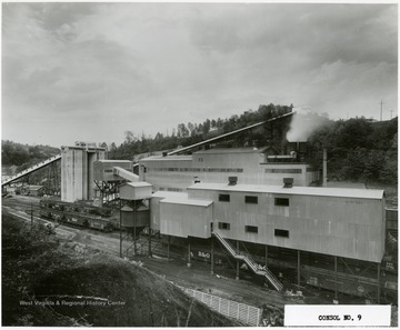 A processing plant at work. Baltimore and Ohio railroad cars beneath the plant.