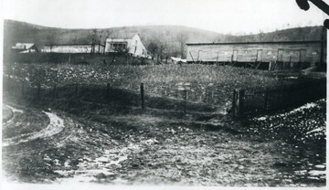 There are two houses next to the barracks.