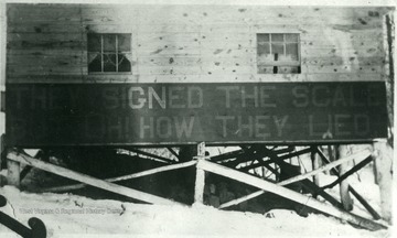 'They Signed the Scale But Oh How they Lied.' Sign posted on the bottom of a barrack.