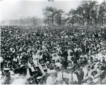 Large crowd possibly at Fairmont. Musicians with instruments are at the front of the crowd.