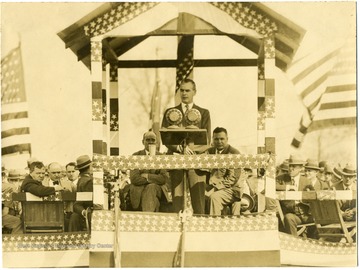 Phillip Murray giving speech in podium decorated in stars and stripes.