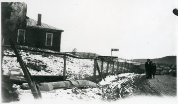 Three men walking by the building.