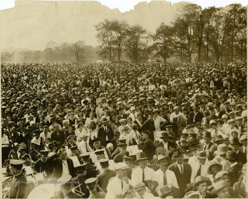 Large crowd possibly at Fairmont. Musicians with instruments are at the front of the crowd.