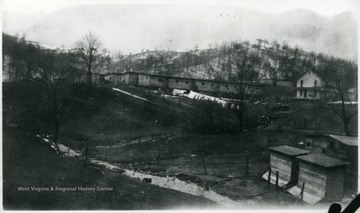 Barracks across creek on hillside at Grant Town, W. Va. Some snow on hillside in background.