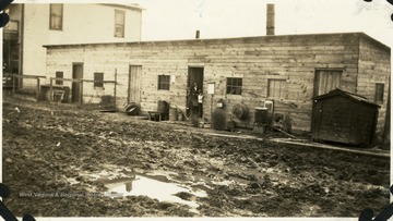 Barrack is situated next to a house.