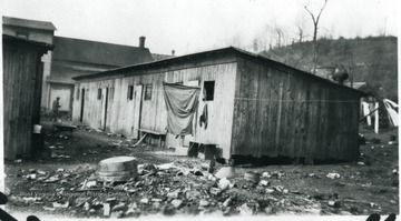 Laundry line is set up outside of the barracks. 