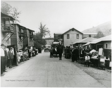 Miners' families with belongings in front of their former houses.