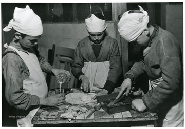 Picture of three children cooking inside the Shack.