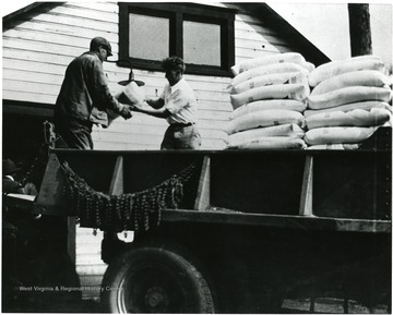 Two men unloading a truck delivery to the Shack.