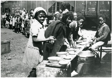 Food line next to train cars.