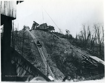 Mine car traveling up hill to waste dump. 'For information on the Mountaineer Mining Mission See A&amp;M 2491 (S.C.).'