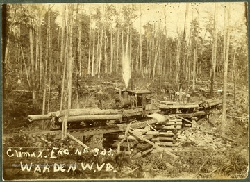 Train engine hauling logs.  Workers standing on logs.  Maben Mill, Raleigh County. "Mrs. J.C. Prince"