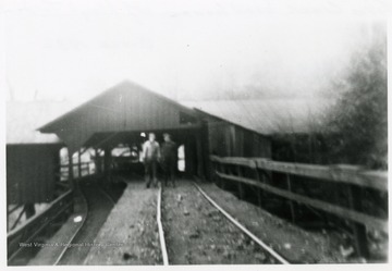 Two men stand by the Head House at Fire Creek.