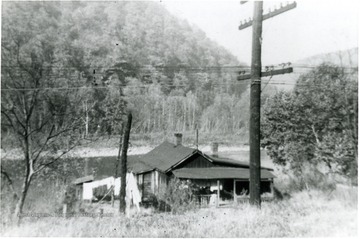 'Showing ice house, showing colored school and church below cliffs.'