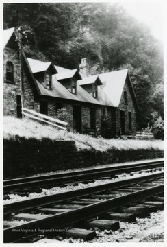 Store building next to railroad tracks.