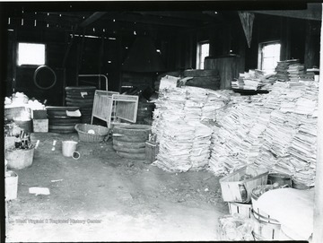 Piles of papers, tires and other materials inside a building at Scott's Run.