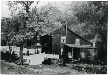 Clothes lines run next to wooden houses.