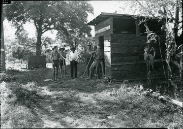 Group of unidentified people besides garden storage.