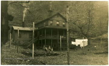 Bennett children are standing in front of the house.