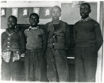 Four African-American students singing at Osage School. 'For more information on Mountaineer Mining Mission see A&M 2491 (S.C.)'L to R: John Boyd, unidentified, likely Tim Johnson's brother, and Tim Johnson