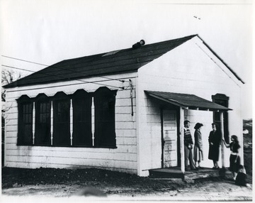 Poeple stand on the stoop of a church building. 'For more information on Mountaineer Mining Mission see A&amp;M 2491 (S.C.)'