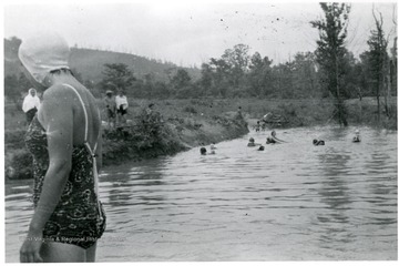 Group of people are swimming, possibly American Friends Service committee workers.