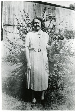 Cesira Viola stands next to a bush for a picture.