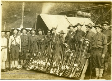 National Guardsmen stand with a slew of guns. 'For similar images see HB Lee Collection.'