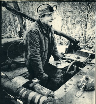 'A day shift worker at New River Coal Co.'s Stanaford mine mans a locomotive hauling supplies into a working section of the underground  mine Monday. 160,000 members of the United Mine Workers of America may walk off the job when the present contract runs out midnight Thursday unless a new contract is accepted (AP Laserphoto) James Samsell1121100str) 1981."