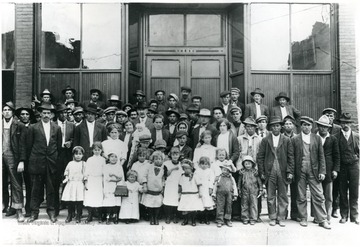 Refugees stand in front of an assembly hall at Trindad, Colorado.