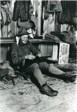 A trooper takes a break to clean his rifle.