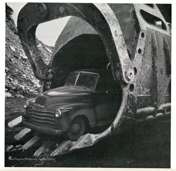 'Close-up view of dipper on 50 cubic-yard shovel at Georgetown No. 12 Mine of Hanna Coal Company, Division of Pittsburgh Consolidation Coal Company. These electric shovels are used to remove the earth and rock overburden from the coal seam. In a month's time, they will each remove as much as 1,600.000 cubic yards, or some 2,400.000 tons. If this material were to be loaded into open railroad cars, it would fill some 48,000 of them.'