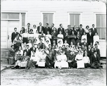 Group portrait of club members holding flags indicating their club affiliation.