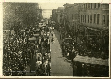 Townspeople along the street watch as circus performer pass by in Beckley, West Virginia.