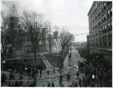 Fire hoses stretched across the old Capitol grounds are used to extinguish the fire.