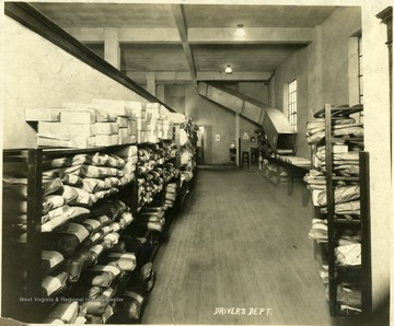 Interior view of the Empire Laundry Company in Clarksburg.  Wrapped packages line the shelves of the drivers department.