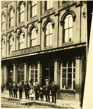 Group of people standing on the sidewalk in front of Brinkman's store in Grafton, W. Va.