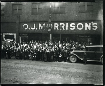 Santa Claus is surrounded by children in front of O. J. Morrison's Store in Grafton, West Virginia.