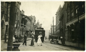 Ladies pass behind a trolley car in Grafton, W. Va.