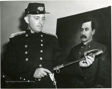 Marine unsheathing a sword. 'Official Marine Corps Photograph, Photographic Section MCS, Quantico, Va. MCS 2-1446-59.'