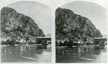 View of Maryland Heights from across the Potomac River and the covered railroad bridge at Harpers Ferry, Virginia,, later West Virginia, before 1861 and the Civil War.