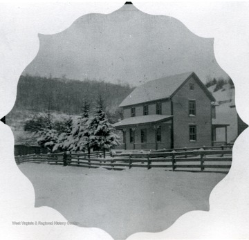 Two story wood frame home on a snowy day.