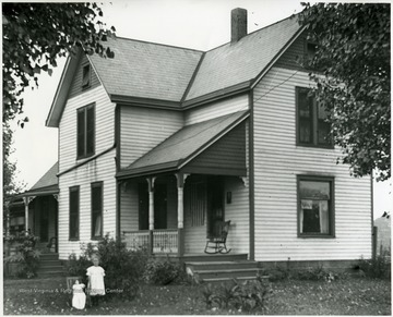 Reverend Benjamin Holtkamp home, Mitawanga, Ohio, daughter Grace in the front yard. 