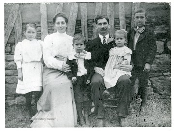 Sutton Family members seated outside for a portrait.