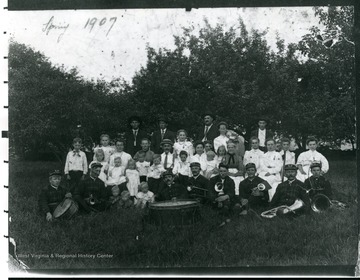 Members of the Helvetia Band with their instruments, gather outside for a portrait.