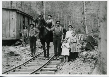 Lumber camp bunkhouses are visible at left.