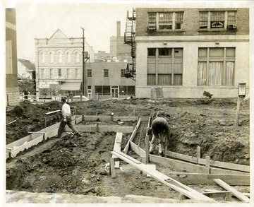 Two construction workers are building footers of the New Courthouse Square in Morgantown, West Virginia. 